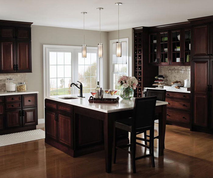 Dark cherry kitchen cabinets with glass cabinet doors by Decora Cabinetry