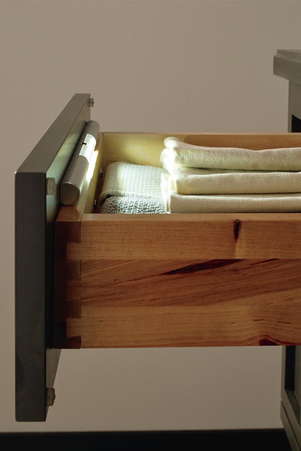 Cabinet drawer open to show battery powered light inside