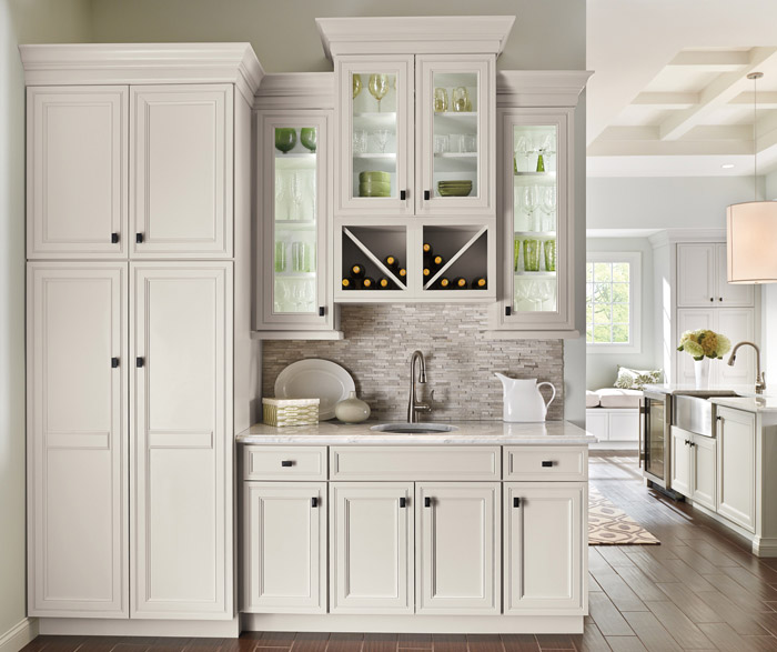 Wet bar area in kitchen with off white cabinets